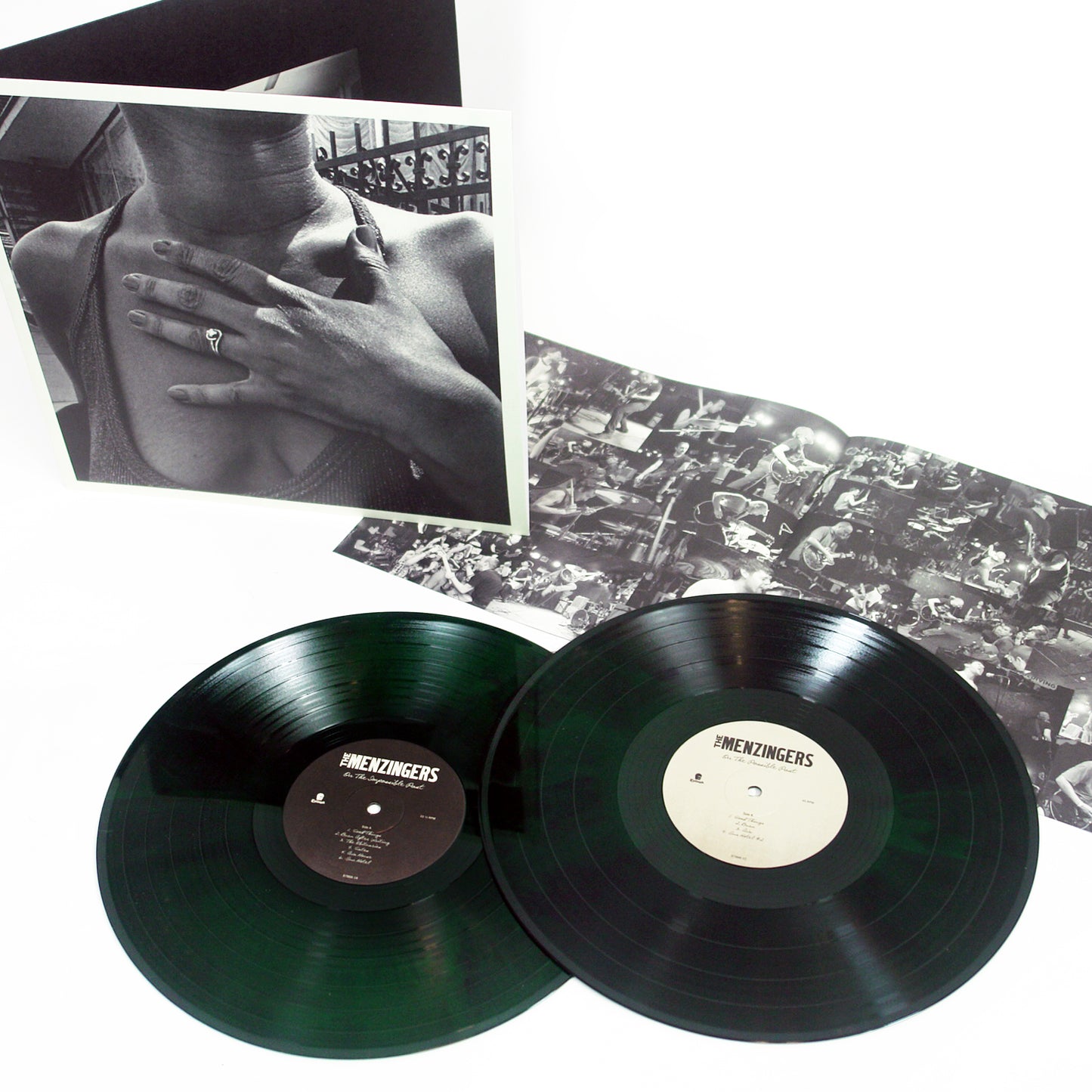 image of two neon green and black vinyls for the menzingers album on the impossible past on a white background. the album cover is a black and white photo of a woman with her hand over her chest and gatefold, open with the 8 page booklet laid out to show black and white images of the band playing at concerts